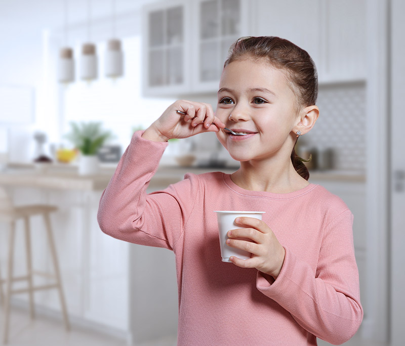 little girl eats yoghurt
